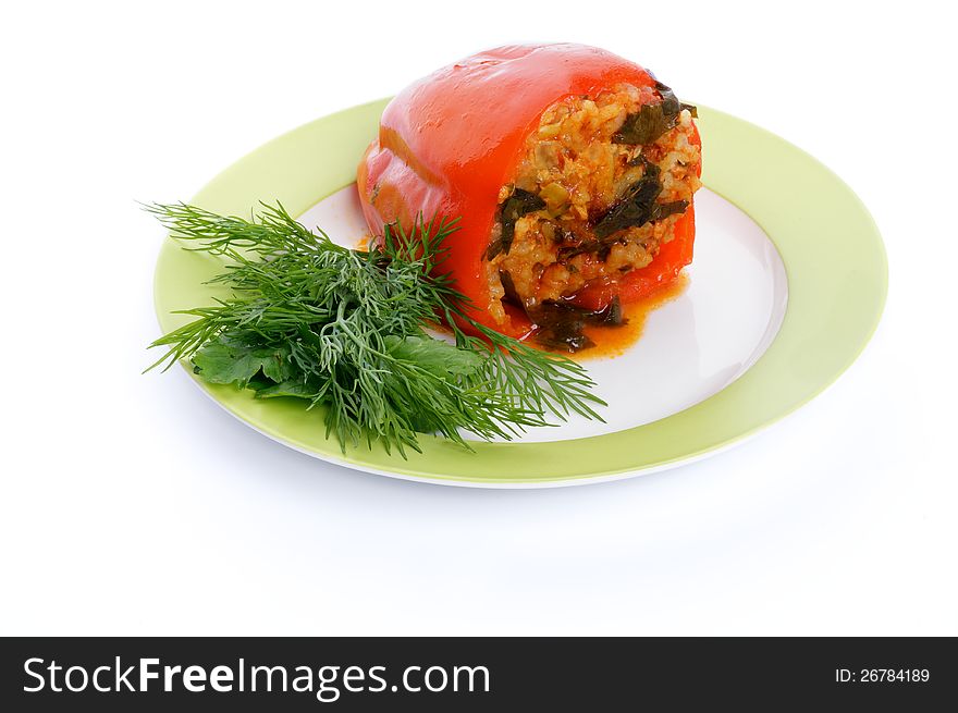 Homemade Red Bell Pepper Filled with Rice, Meat, Onion and Parsley on green plate isolated on white background. Homemade Red Bell Pepper Filled with Rice, Meat, Onion and Parsley on green plate isolated on white background