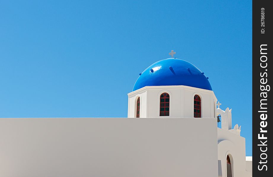 White, Christian church with blue dome, is shown in the background of blue sky. White, Christian church with blue dome, is shown in the background of blue sky.