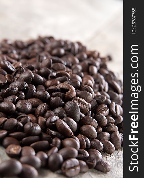 Close up of coffee beans on old wooden table