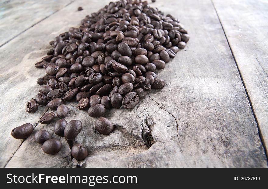 Close up of coffee beans on old wooden table