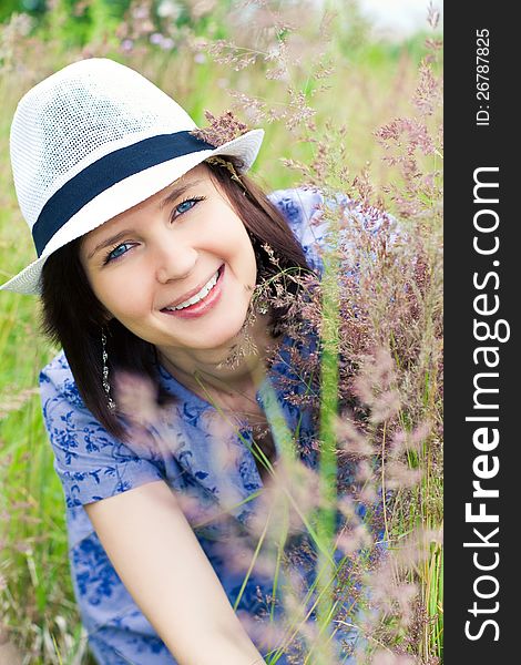 Smiling girl in hat on the meadow. Smiling girl in hat on the meadow
