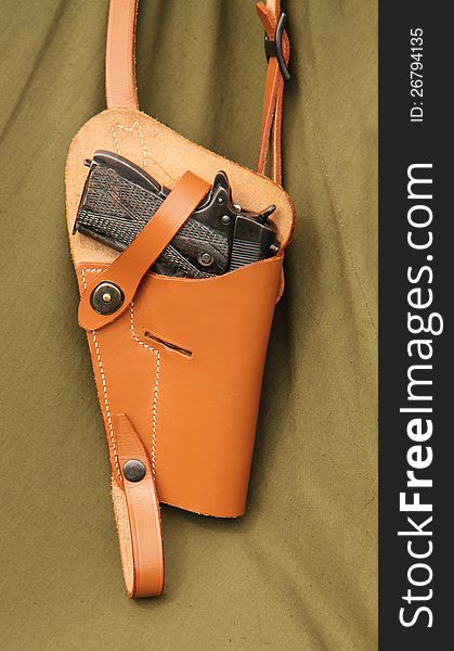 A Vintage Pistol Hand Gun Hanging in a Leather Holster. A Vintage Pistol Hand Gun Hanging in a Leather Holster.