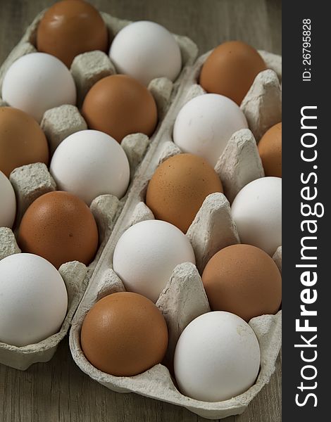 Eggs in the package on a wooden table. Eggs in the package on a wooden table