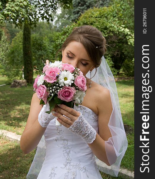 Beautiful bride in white dress with wedding bouquet. Beautiful bride in white dress with wedding bouquet