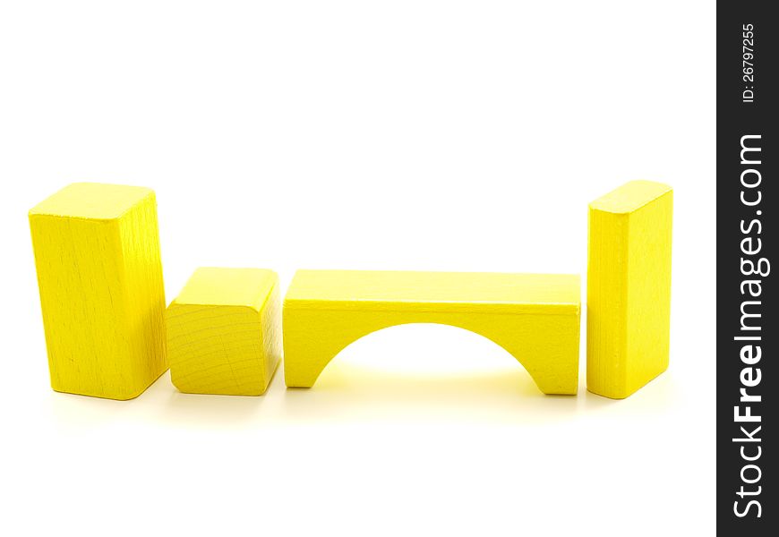 Wooden brick pieces of yellow color,  towards white. Wooden brick pieces of yellow color,  towards white