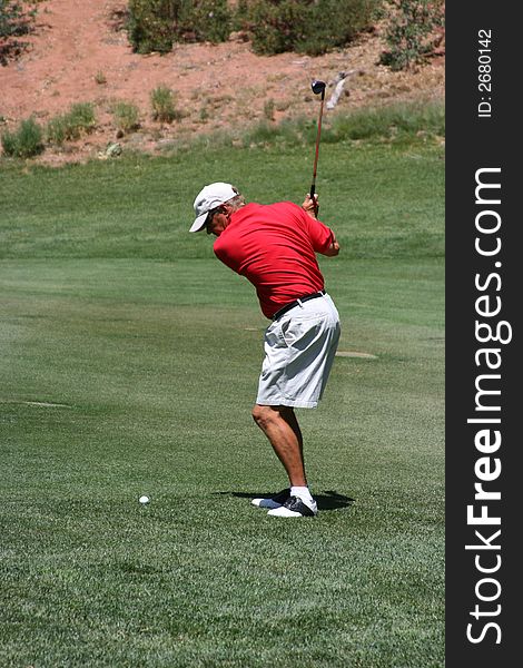 Male about to hit golf ball