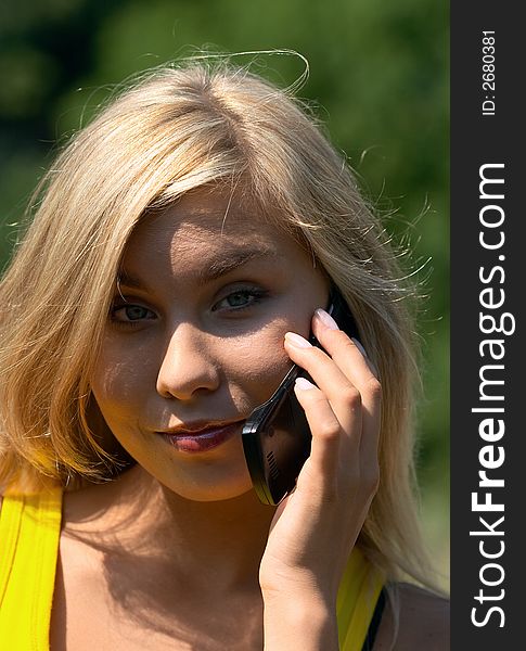 Blonde girl with cellphone in nature scenic. Blonde girl with cellphone in nature scenic