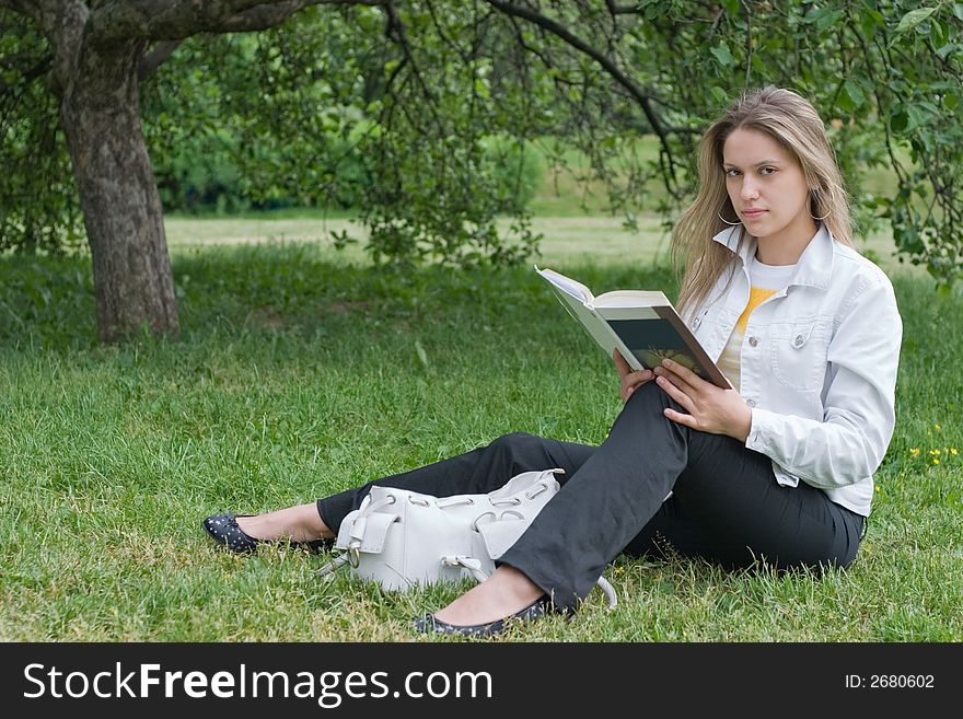 Girl reading book in the park. Girl reading book in the park