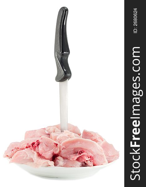 Raw chicken chopped into pieces at the plate with a knife. Raw chicken chopped into pieces at the plate with a knife