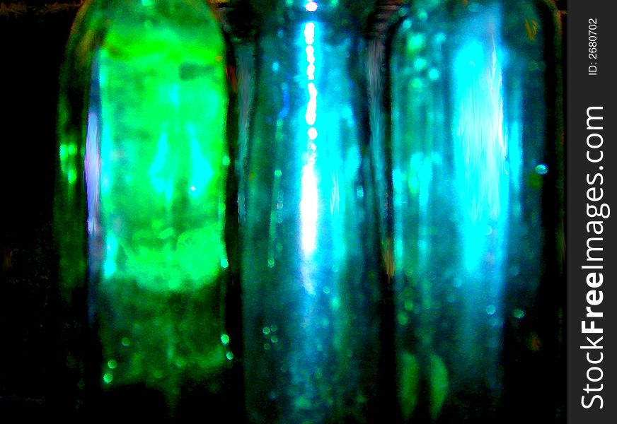 Green and Blue Glass bottles of different geometric shapes. Green and Blue Glass bottles of different geometric shapes