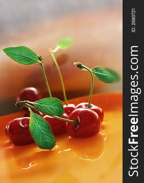 Red cherry with water, against various background