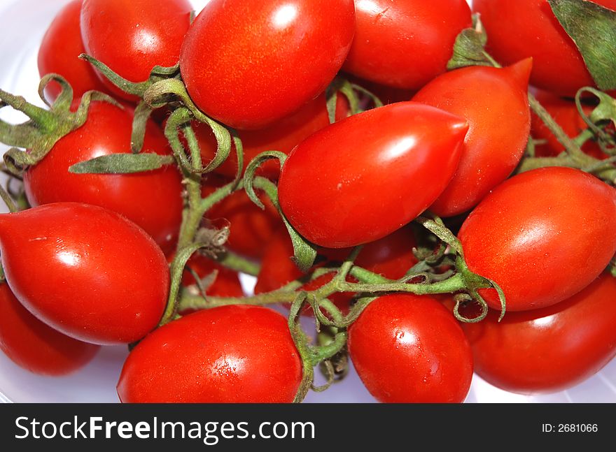 Fresh red tomatoes, white background