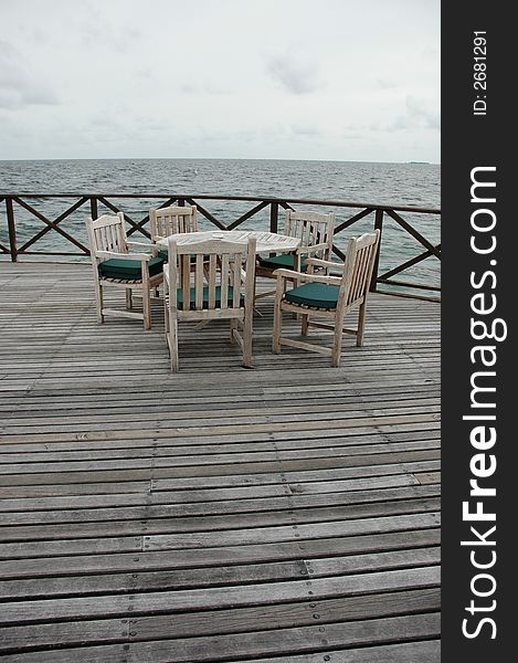 Dining area on a wooden jetty next to the sea. Dining area on a wooden jetty next to the sea