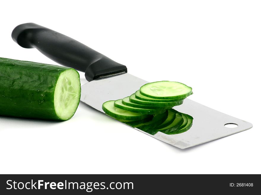 Fresh cucumber sliced with cleaver on a white background. Fresh cucumber sliced with cleaver on a white background