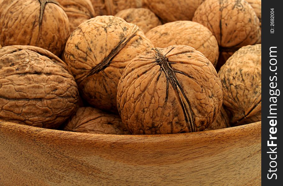 Wooden bowl of organic walnuts