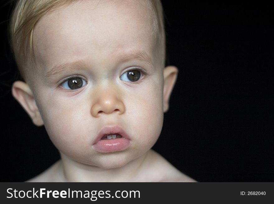 Image of beautiful toddler with a serious look on his face