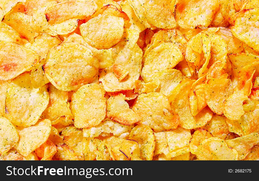 Potato chips close-up view from above, may be used as background