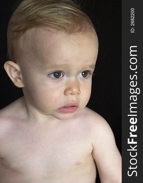 Image of beautiful toddler with a serious look on his face