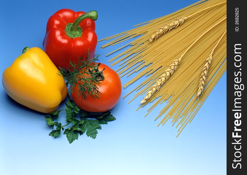 Spaghetti with vegetables on blue background. Spaghetti with vegetables on blue background
