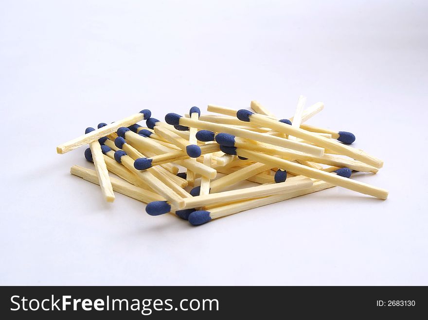 Huddle of matches with white background.