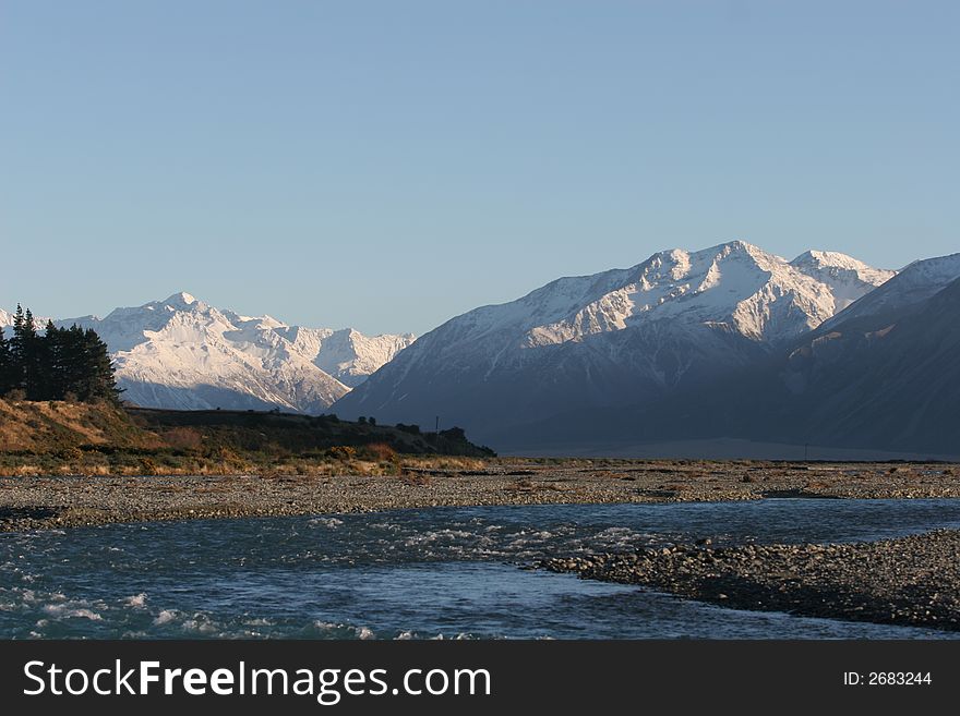 View of one of the southern braids of the Rakaia River in Canterbury, New Zealand.  The near mountain range in the background is called 'Rugged Range'.  The Arrowsmith range is to the left. View of one of the southern braids of the Rakaia River in Canterbury, New Zealand.  The near mountain range in the background is called 'Rugged Range'.  The Arrowsmith range is to the left.