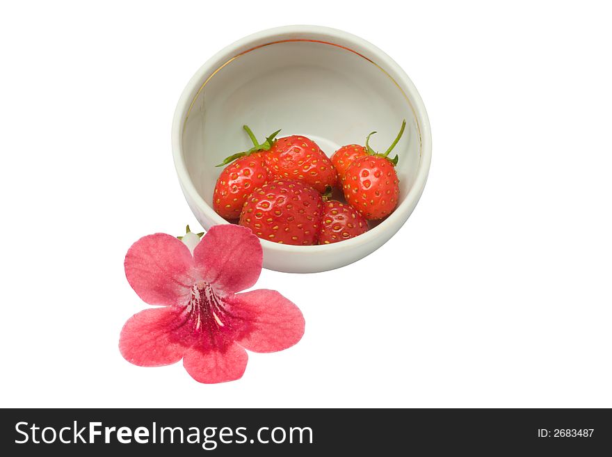 Strawberries in a cup and a flower, isolated on white background, with clipping path in the file. Strawberries in a cup and a flower, isolated on white background, with clipping path in the file