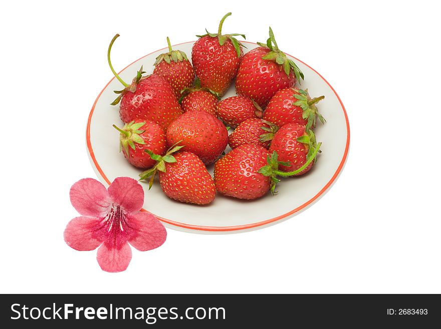 Strawberries on a saucer and a flower, isolated on white background, with clipping path in the file. Strawberries on a saucer and a flower, isolated on white background, with clipping path in the file