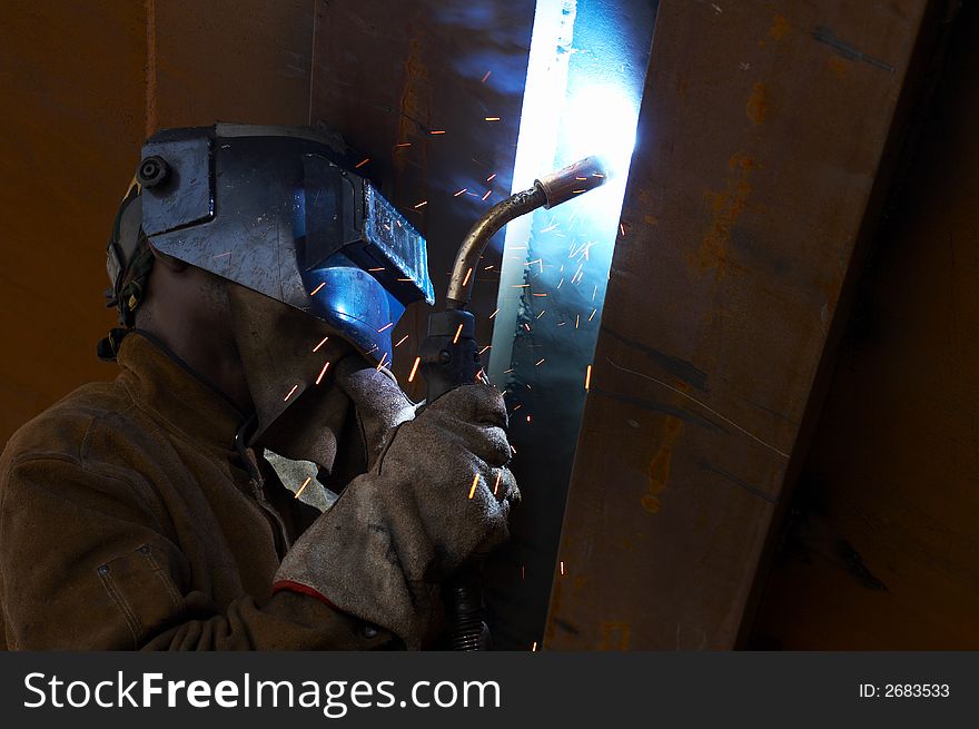 Welder working at night under a ship. Welder working at night under a ship