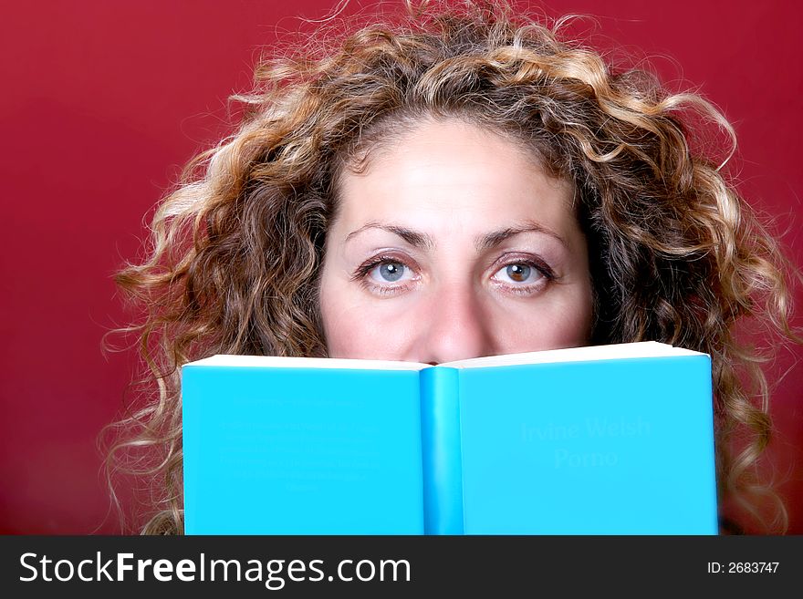 Digital photo of a woman hiding behind a book. Digital photo of a woman hiding behind a book.