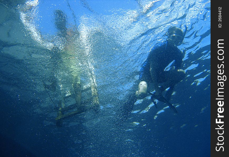Scuba diver exploring a pristine tropical coral reef under water. Scuba diver exploring a pristine tropical coral reef under water