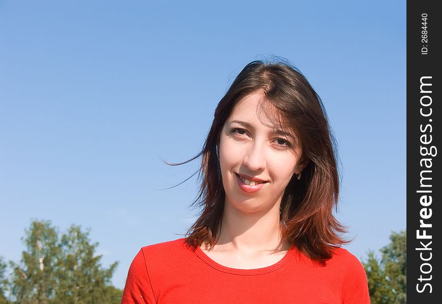 Portrait of the young attractive girl with an attractive smile and a happy look.