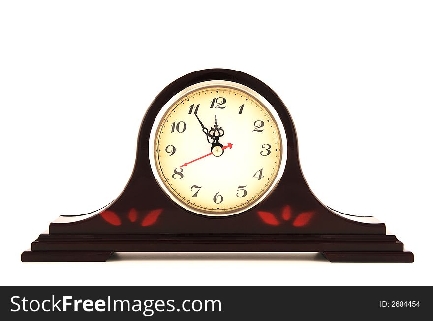 Old fashioned clock showing five minutes to 12.