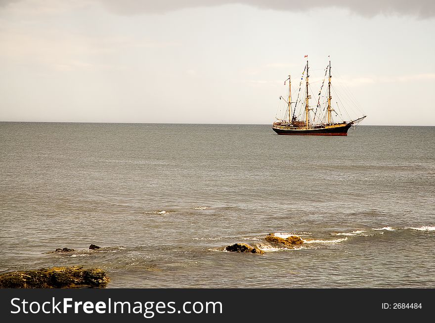 A view of a large sailboat or schooner anchored just off the Atlantic coast in Newport, Rhode Island. A view of a large sailboat or schooner anchored just off the Atlantic coast in Newport, Rhode Island.