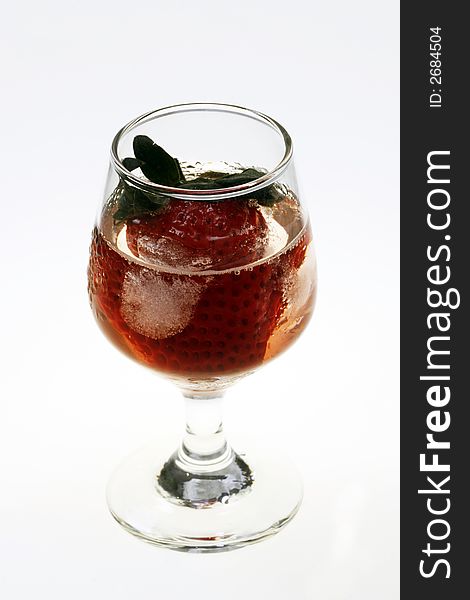 Single strawberry in a glass with ice on white background. Single strawberry in a glass with ice on white background