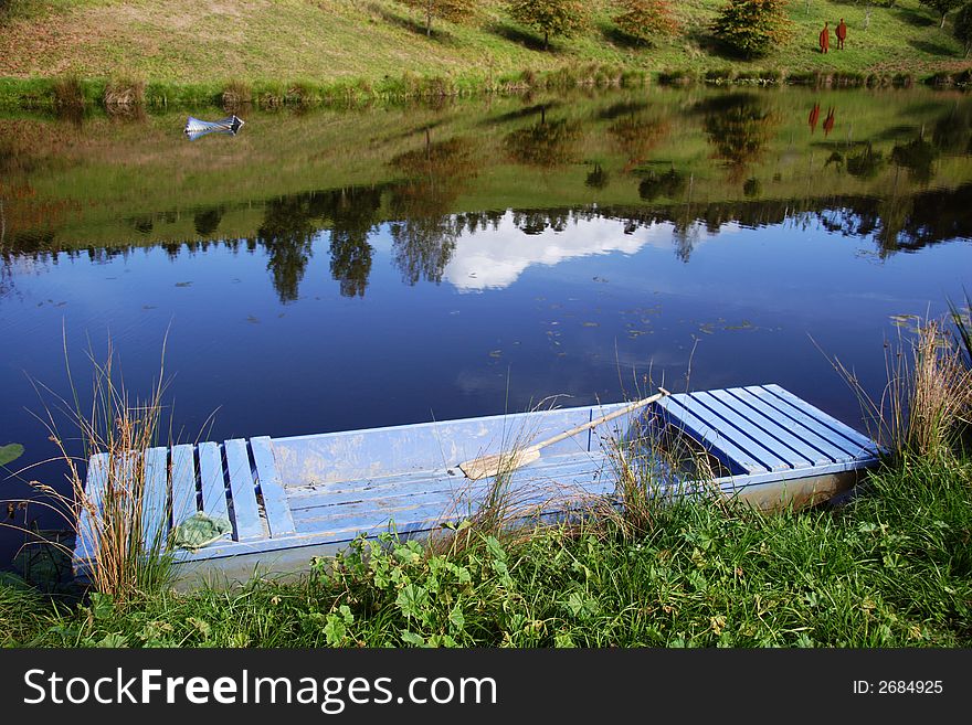 Old wooden boat on pond