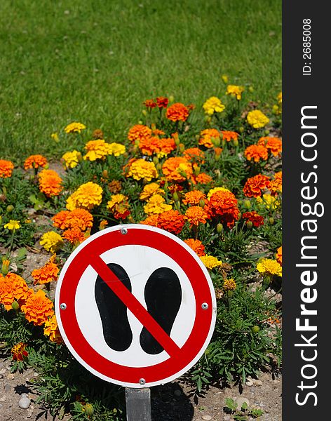 Keep off warning sign with flowers and grass