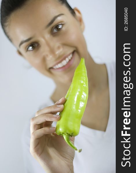 Pretty girl holding fresh green paprika. Pretty girl holding fresh green paprika