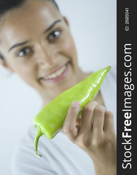 Pretty girl holding fresh green paprika. Pretty girl holding fresh green paprika