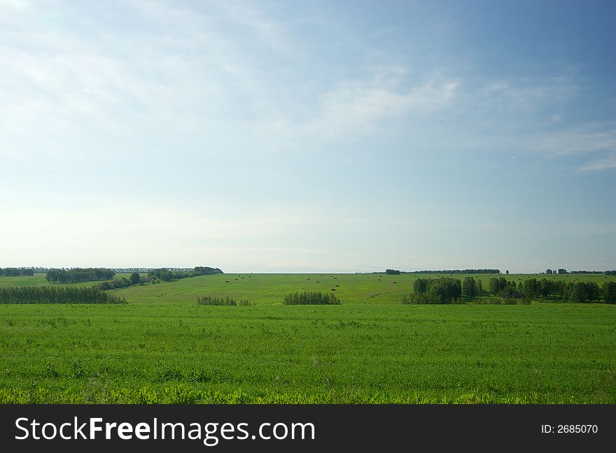 Meadow landscape with cloudscape and haystacks. Meadow landscape with cloudscape and haystacks