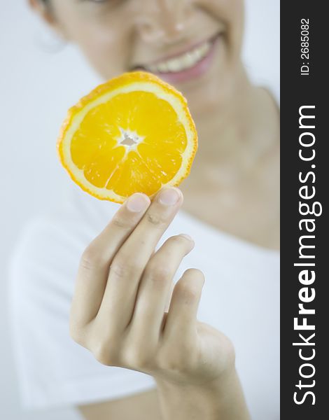 Girl holding piece of orange. Girl holding piece of orange