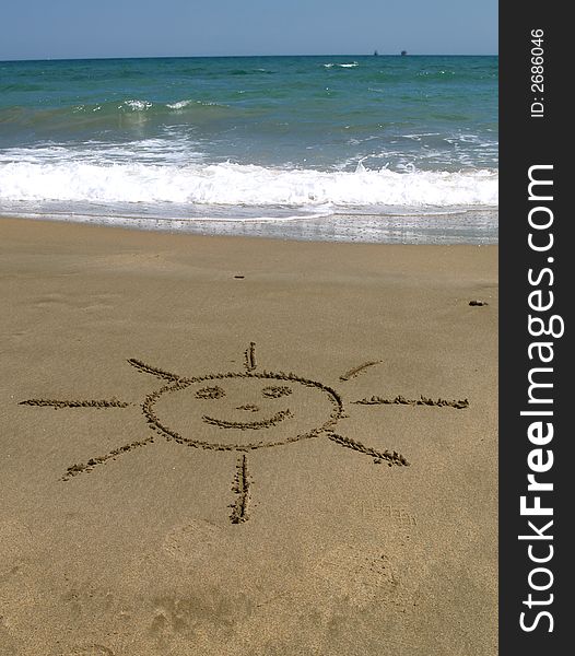 Beach with a sun drawing in the sand. Beach with a sun drawing in the sand