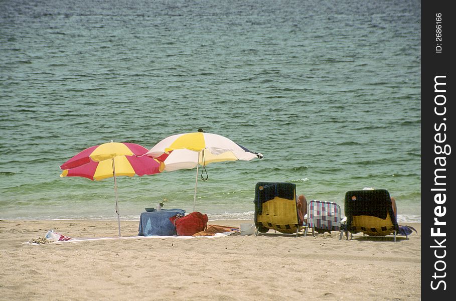 Florida beach scene with ocean and beach chairs