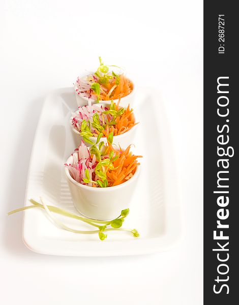 Carrot and radish salad in white bowls. Carrot and radish salad in white bowls