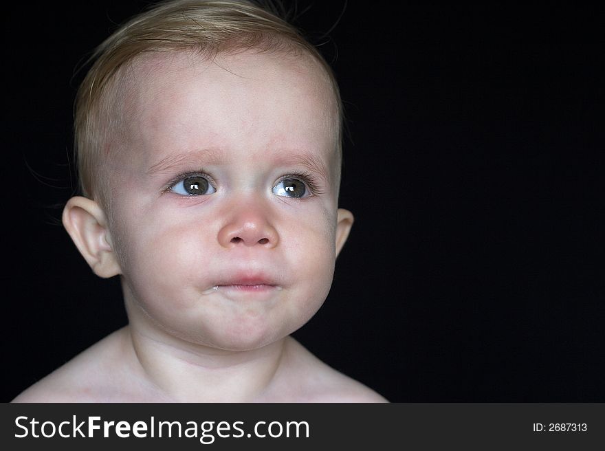 Image of beautiful toddler with a thoughtful look on his face