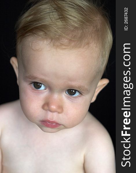 Image of beautiful toddler with a serious look on his face