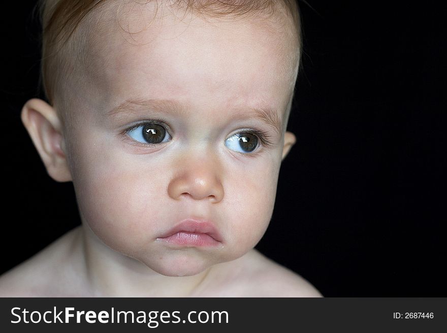 Image of beautiful toddler with a serious look on his face