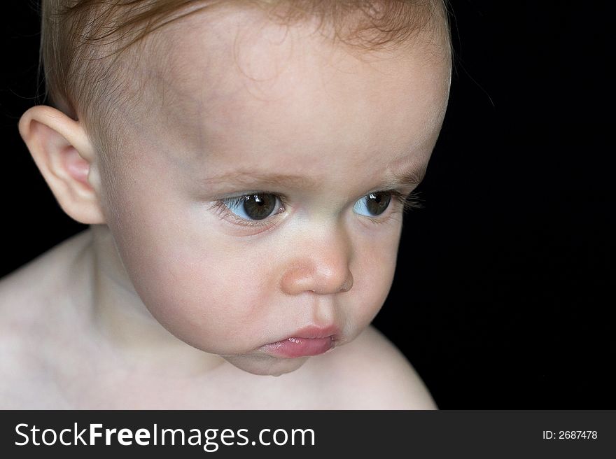 Image of beautiful toddler with a serious look on his face