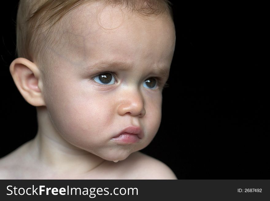 Image of beautiful toddler with a serious look on his face