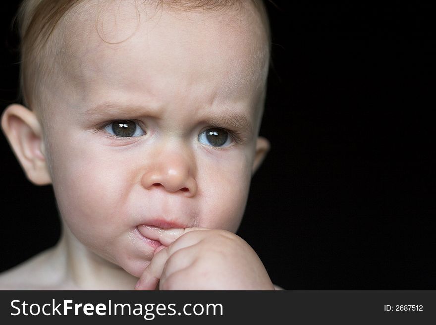 Image of beautiful toddler with a serious look on his face