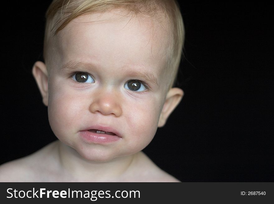 Image of beautiful toddler with a serious look on his face